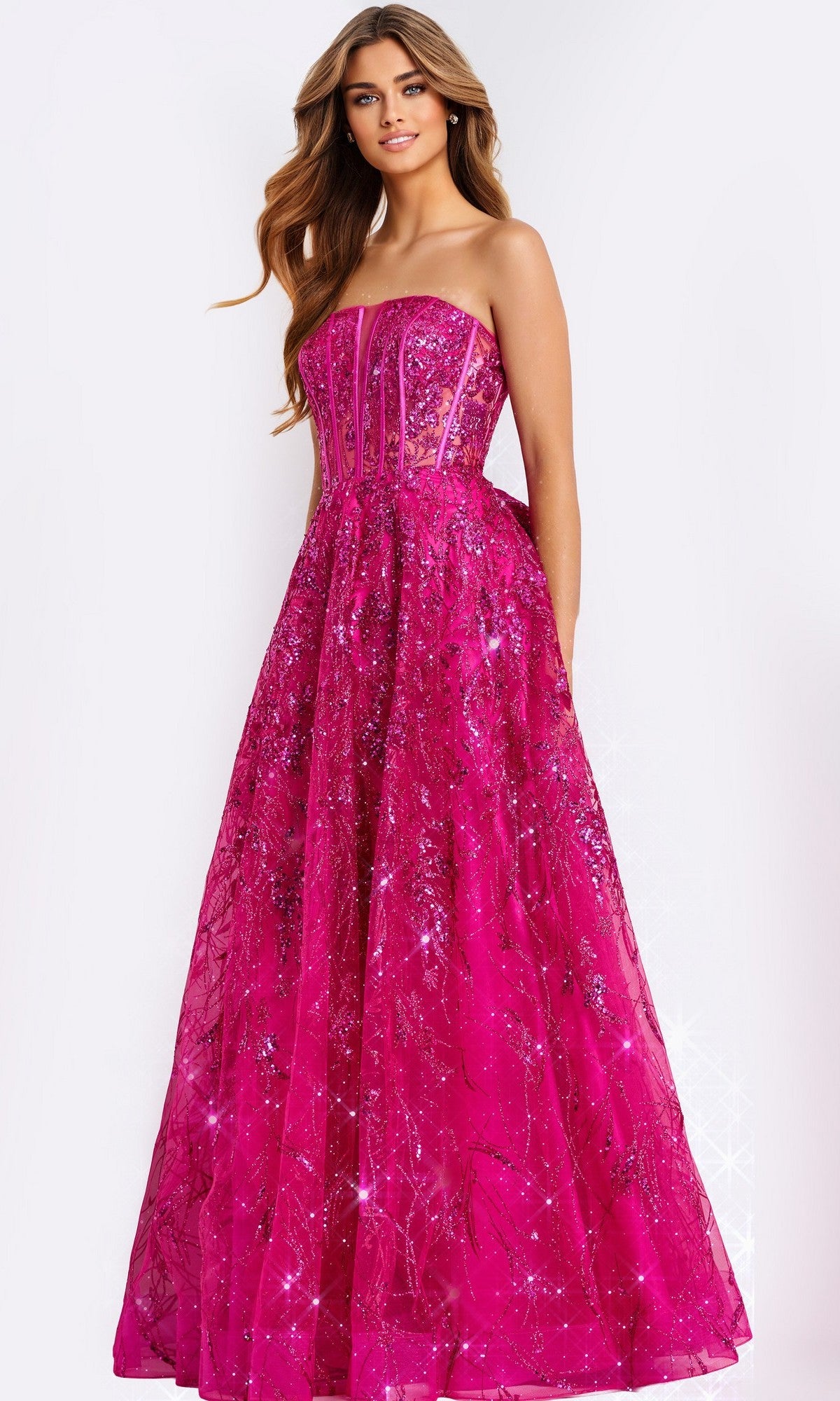 A woman wears the Jovani 45913 long prom dress, featuring a strapless corset bodice and flared skirt adorned with bright pink sequins, standing against a white background.